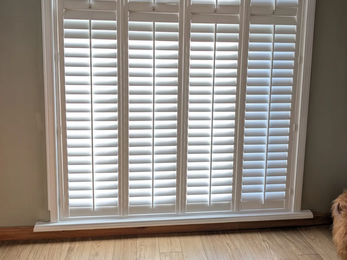 White plantation shutters fitted to a Victorian bay window in Glasgow