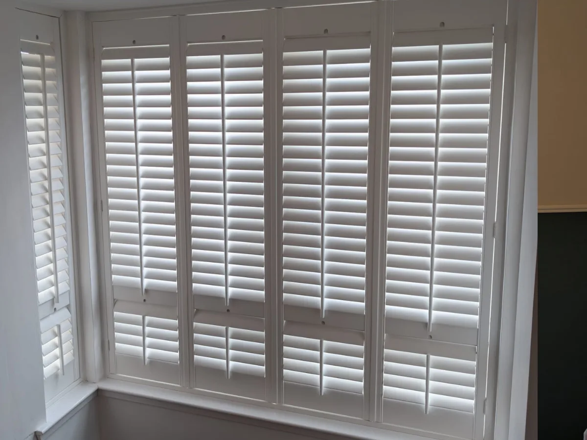White plantation shutters fitted to a bay window in Kildrum, Cumbernauld