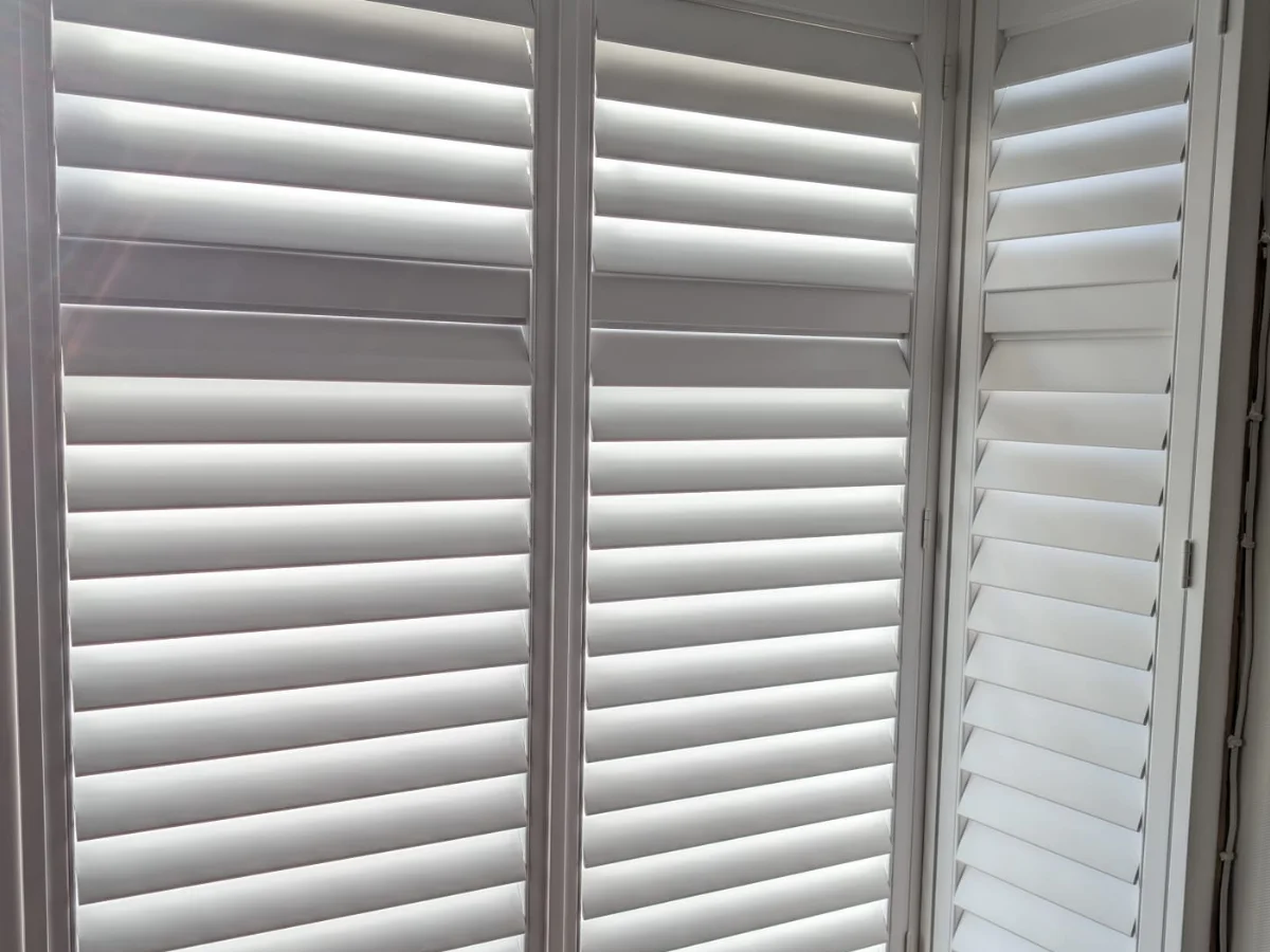 White plantation shutters fitted to a bay window in Kildrum, Cumbernauld