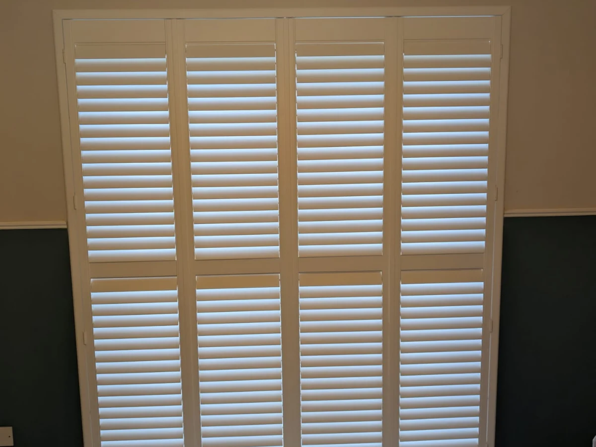 White plantation shutters fitted to a bay window in Kildrum, Cumbernauld