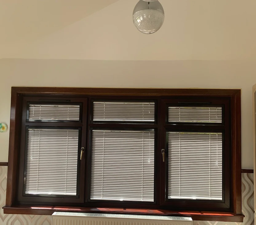Light-coloured Venetian blinds fitted to a wide kitchen window in Bridge of Allan near Stirling